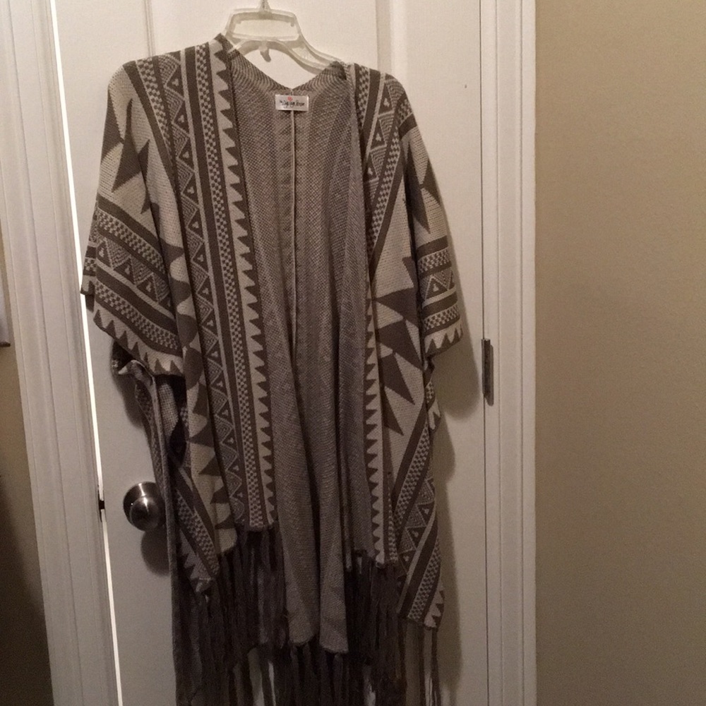 Poncho sweater with fringed bottom